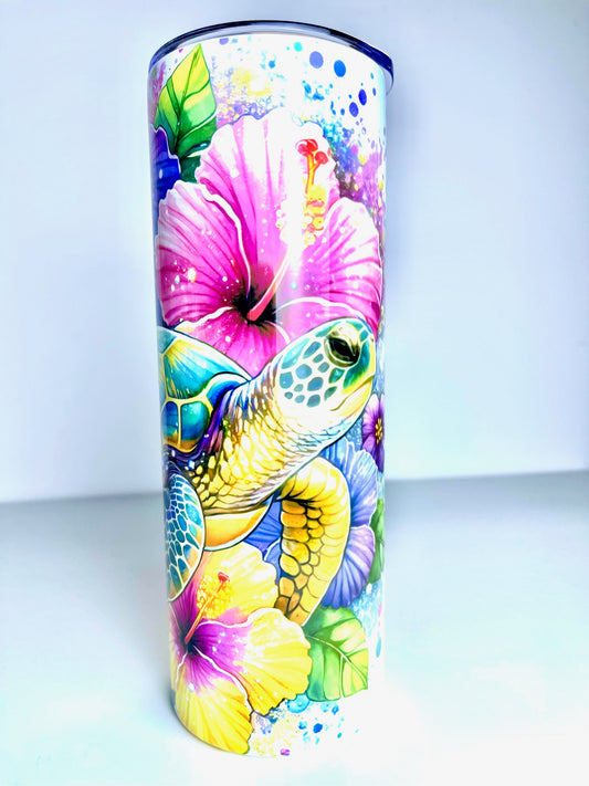 Tumbler with a colorful design of a turtle and flowers on a white background